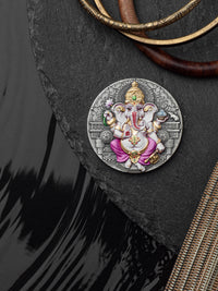 Decorative pendant with a figure of Ganesha on a dark surface