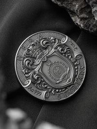 Decorative coin with intricate designs on a dark background