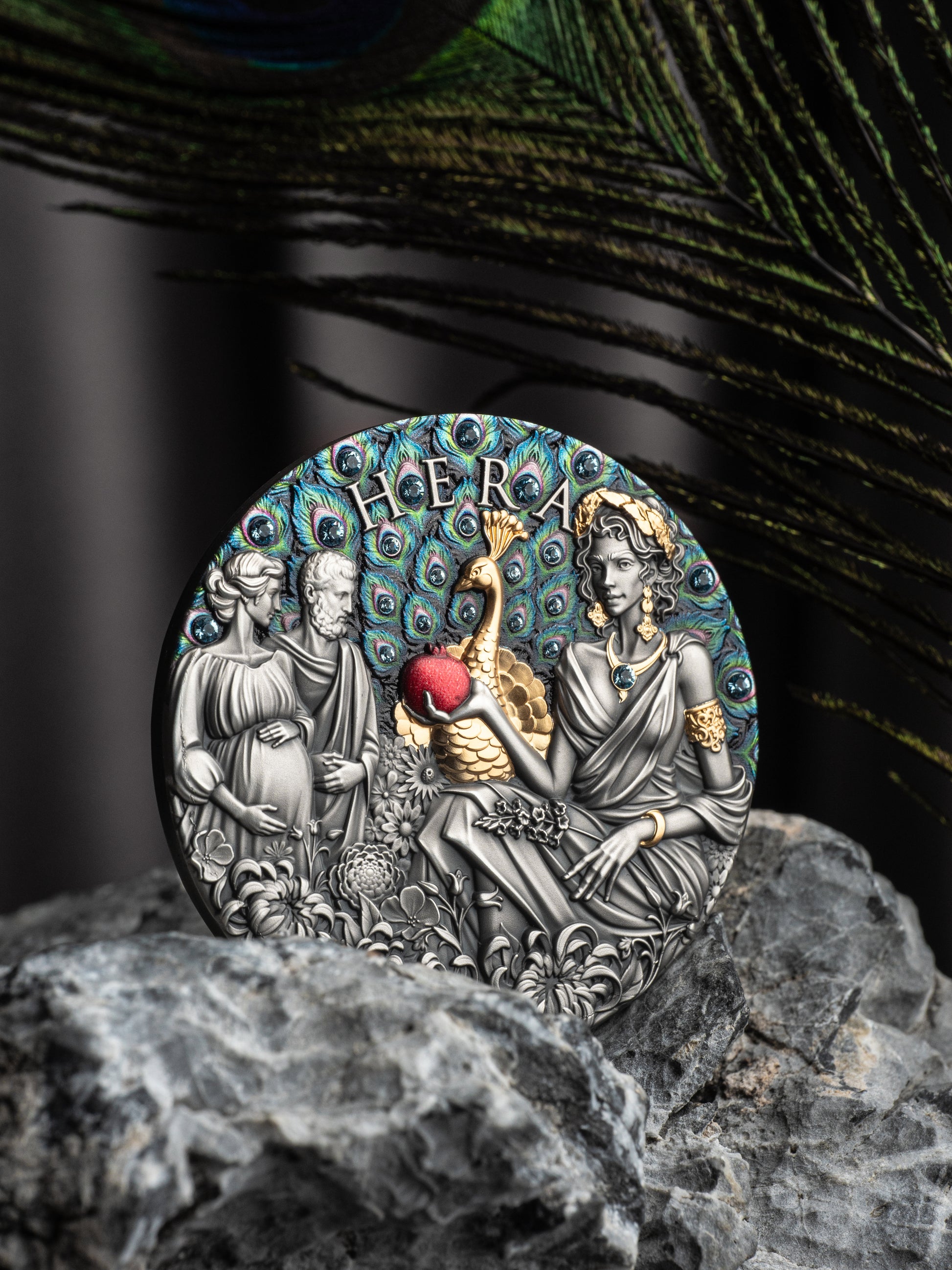 Decorative coin with 'Hera' and classical design on a peacock feather background