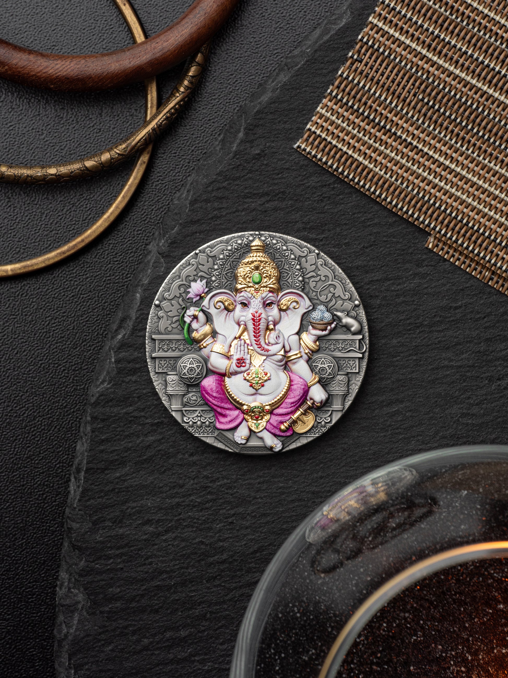 Decorative pendant with an intricate design on a dark surface
