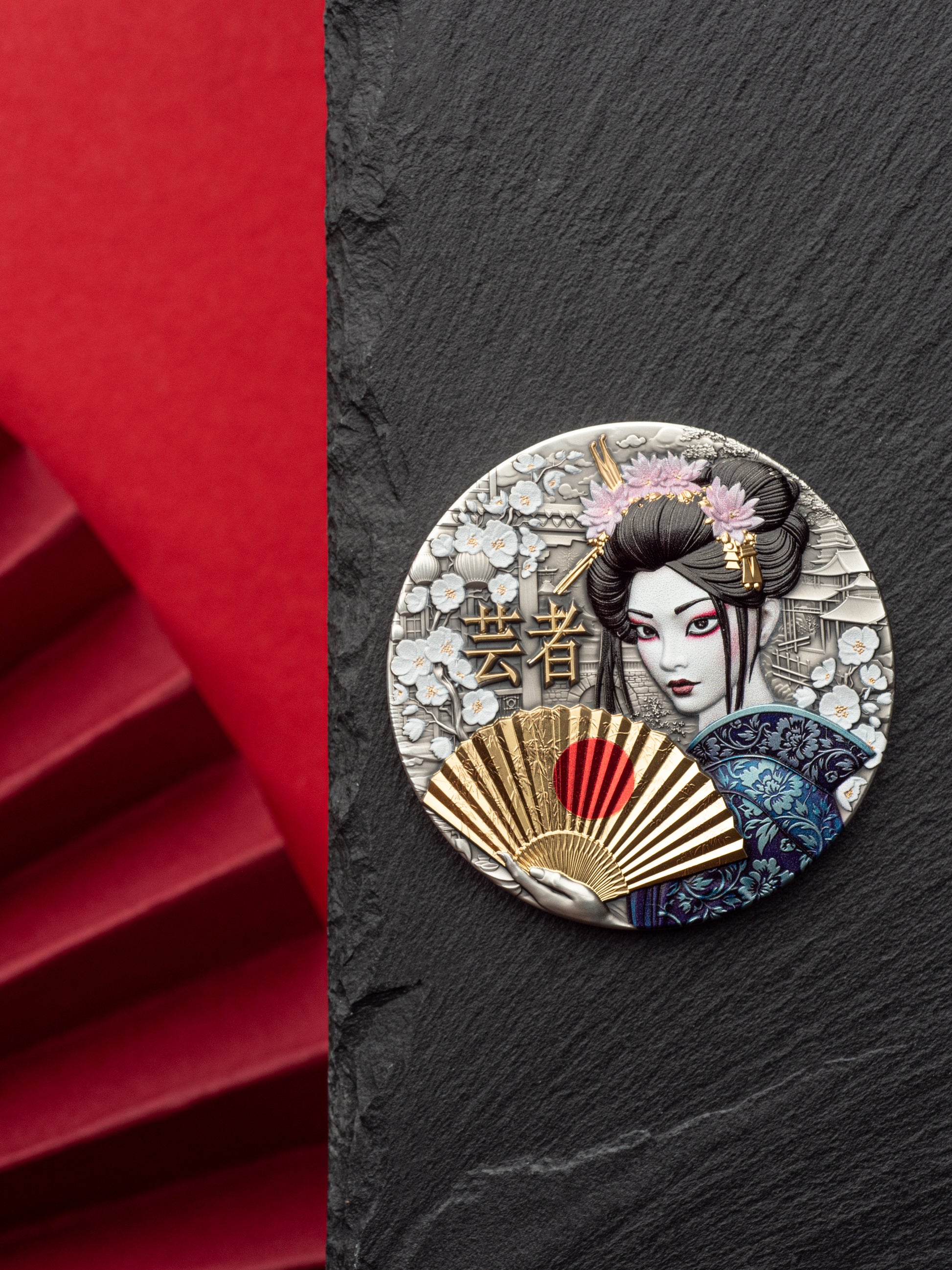 Decorative brooch with a geisha design on a black slate background