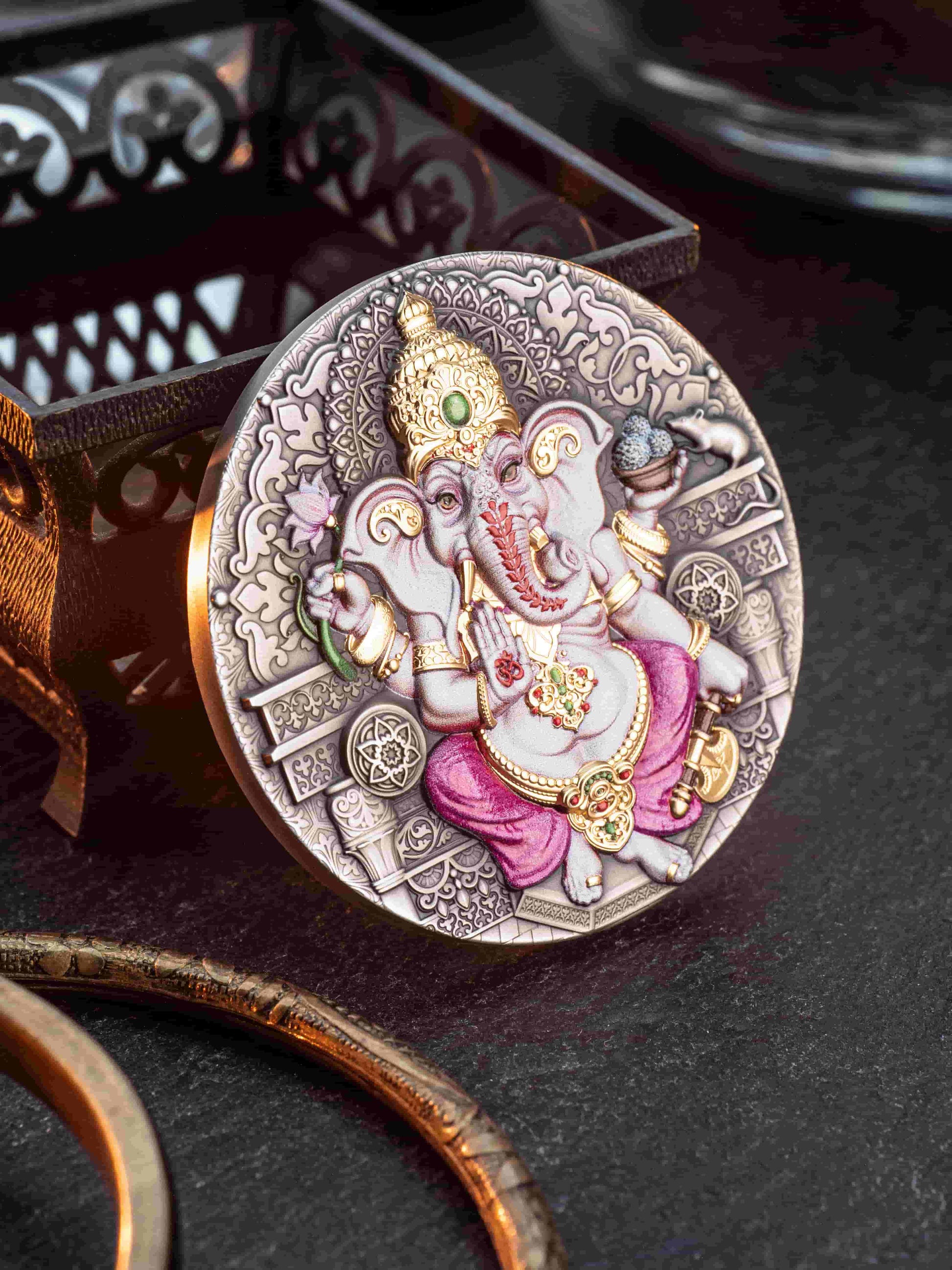 Decorative coin with an elephant figure on a dark surface