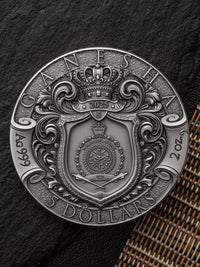 Silver coin with intricate design and text on a textured surface