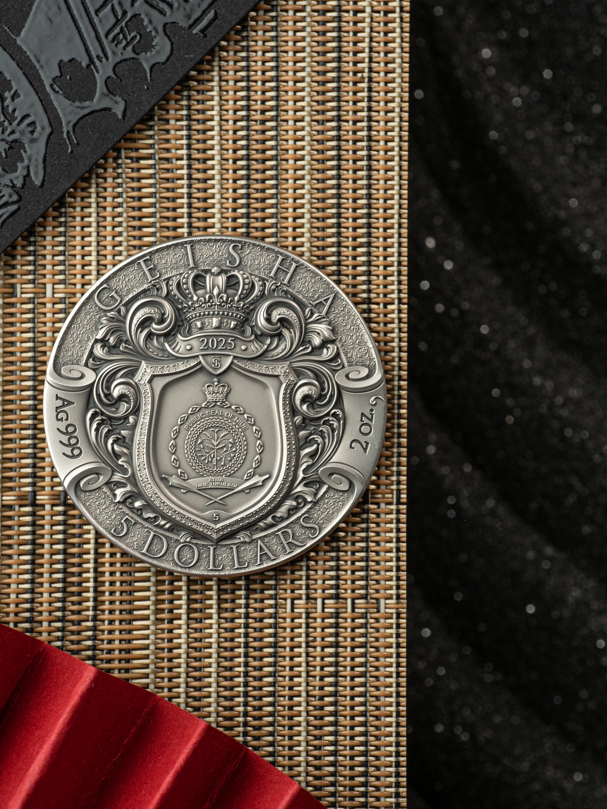 Silver coin with intricate design on a textured surface