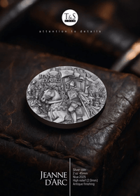 Silver coin featuring Jeanne d'Arc on a dark leather surface with T&S logo.