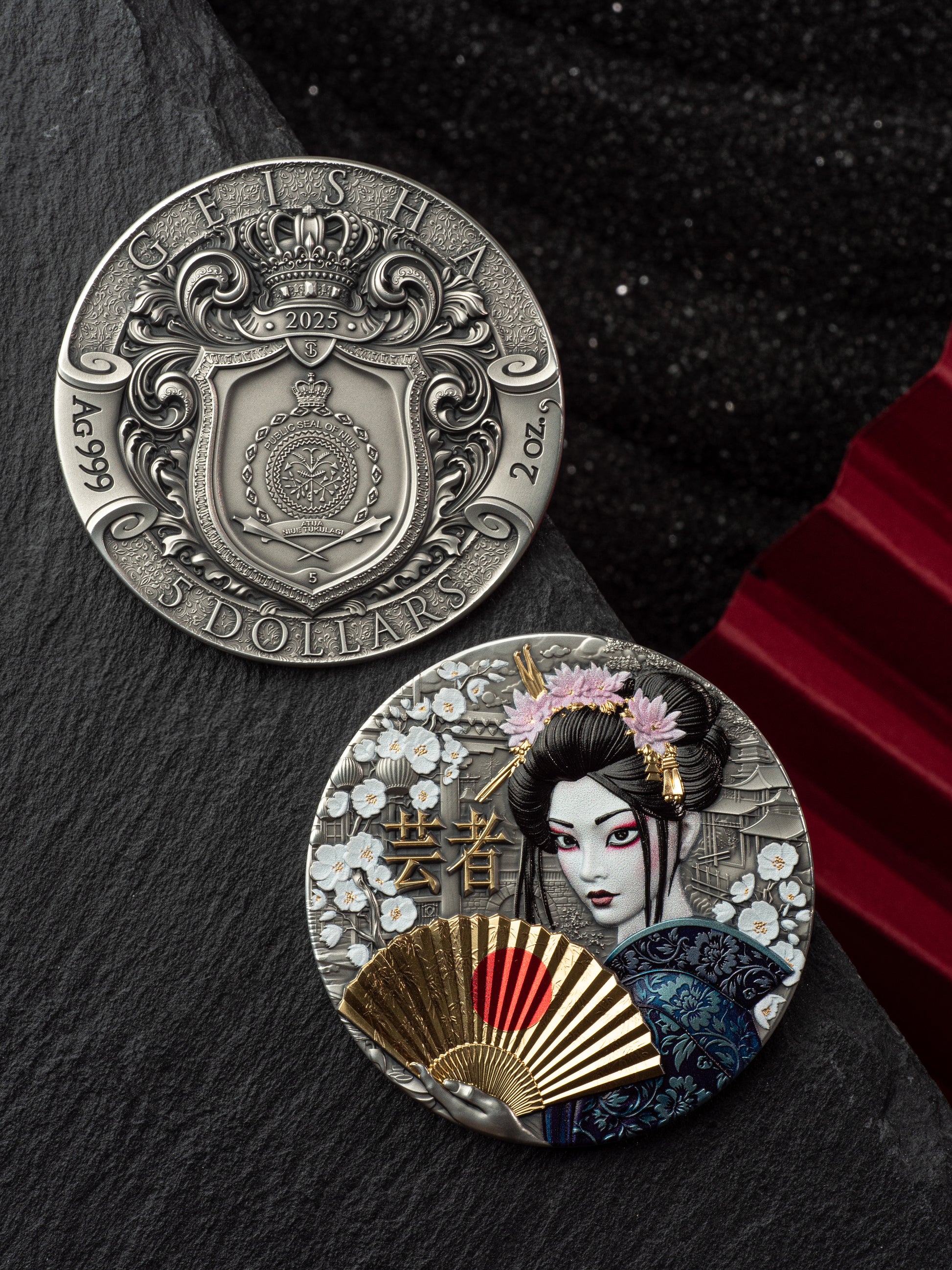 Two silver coins with intricate designs on a dark surface