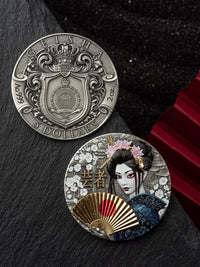 Two silver coins with intricate designs on a dark surface