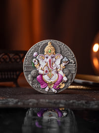 Decorative coin with an illustration of a deity on a reflective surface.