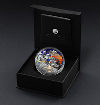Colorized coin featuring a character from 'Aladdin' in a black display box on a dark background