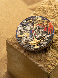 Decorative coin featuring Aladdin and the Magic Lamp on a sand-like background
