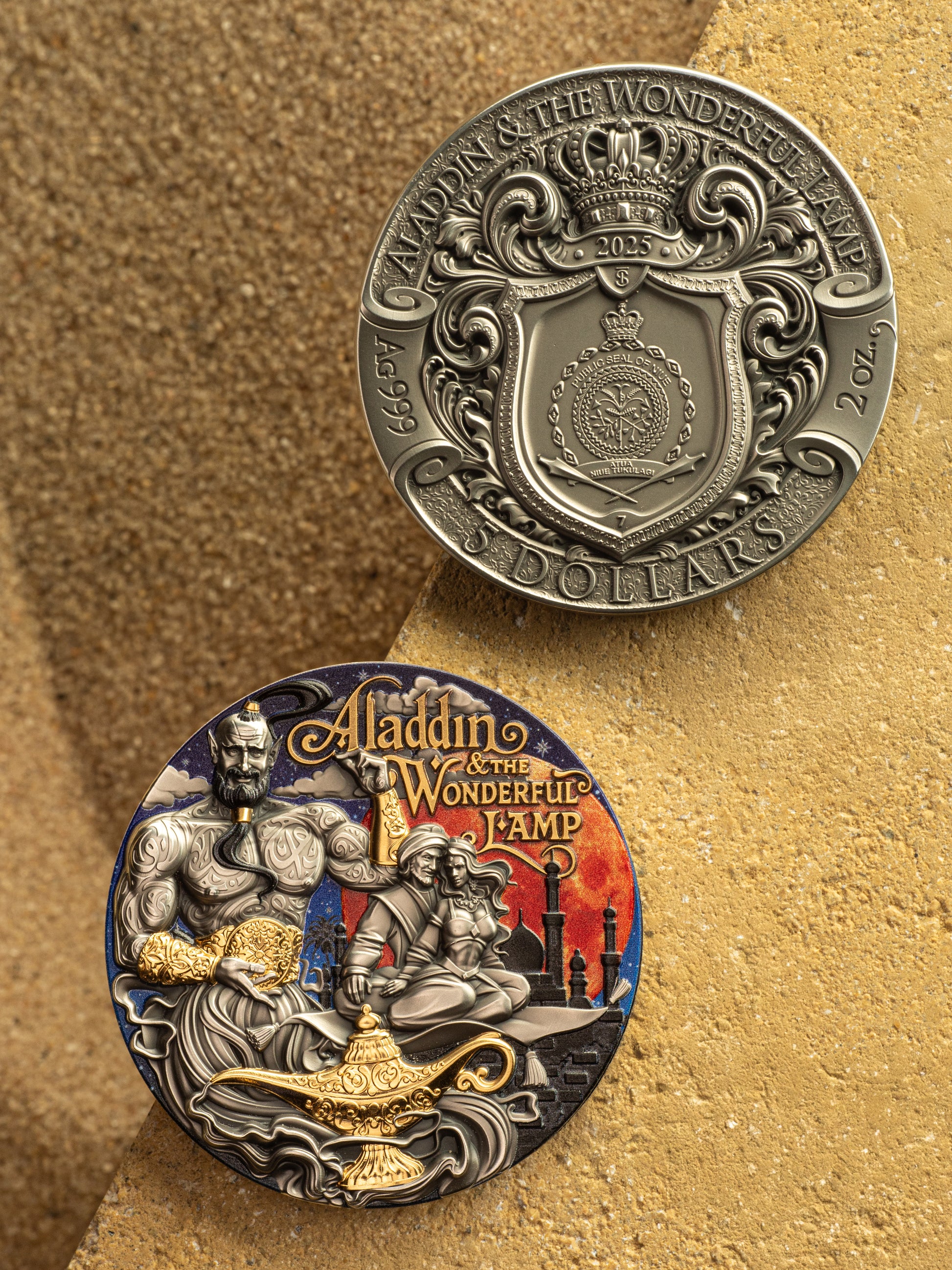 Two coins featuring Aladdin and the Wonderful Lamp design on a textured gold background.