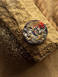 Decorative button with intricate design on a textured surface