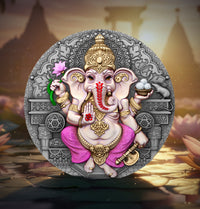 Decorative plaque of an elephant god with intricate designs on a blurred temple background