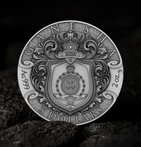Silver coin with intricate designs and text on a dark background