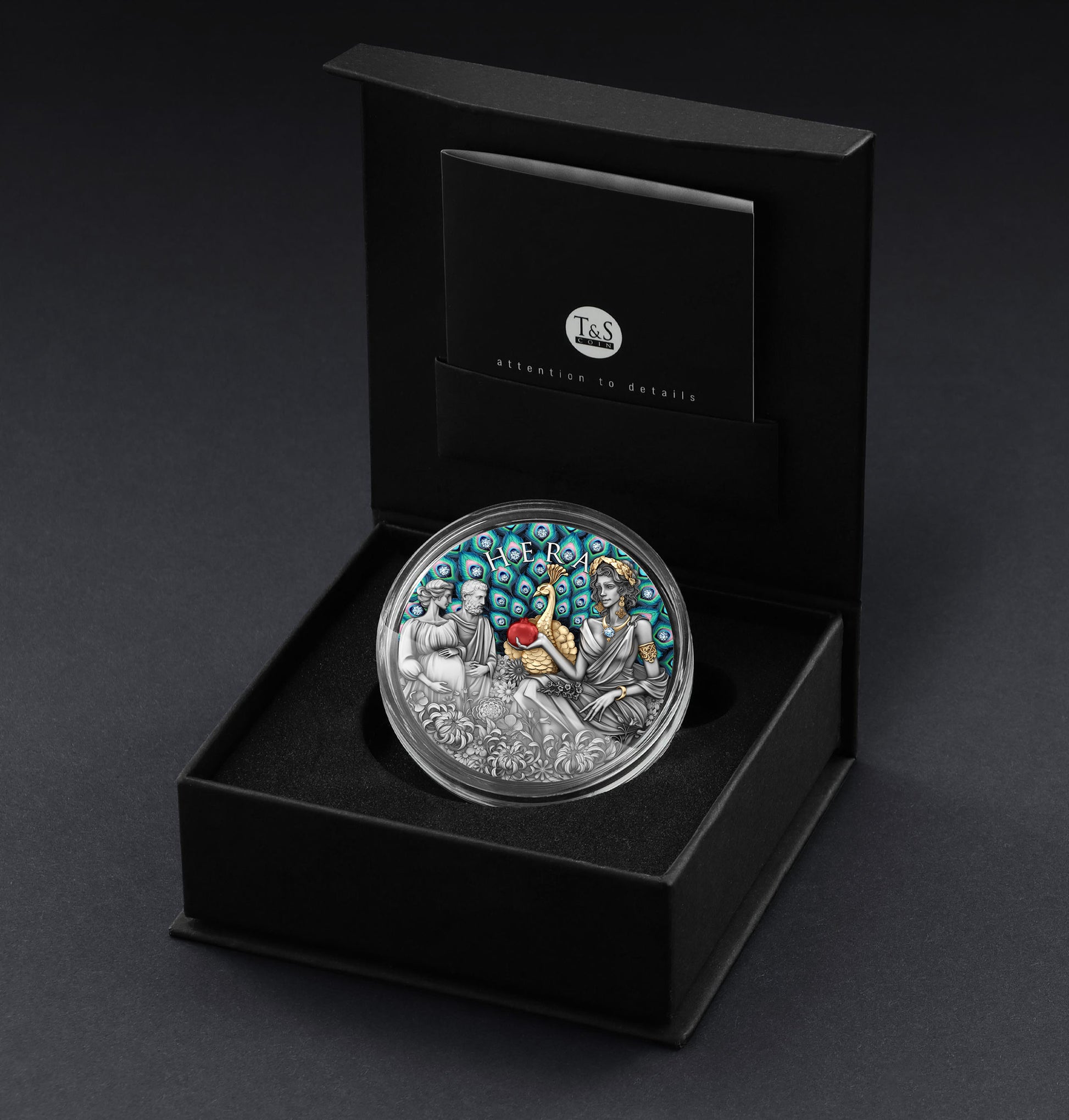 Silver coin with detailed design in a black box on a dark background