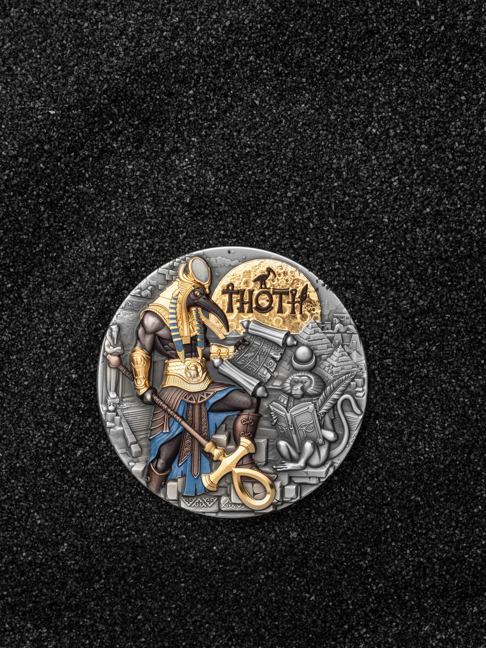 Decorative coin with a figure of Thor on a black background