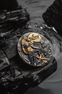 Decorative coin with a warrior design on a dark stone surface