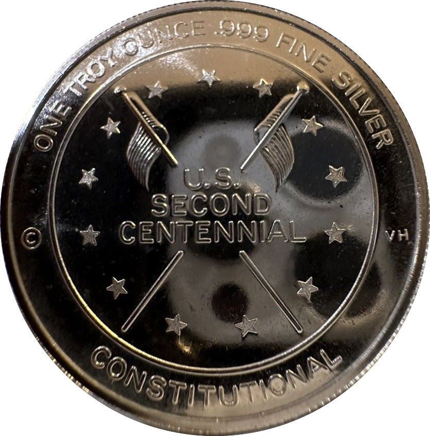 Silver coin with U.S. Second Centennial design on a white background