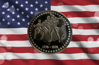 Coin with historical design on an American flag background