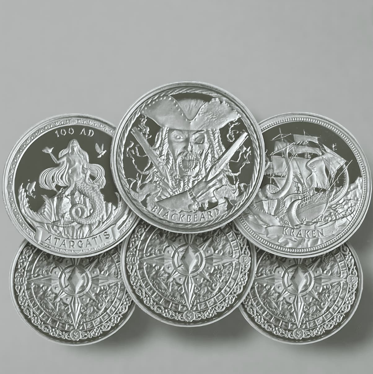 silver coins with various designs on a gray background